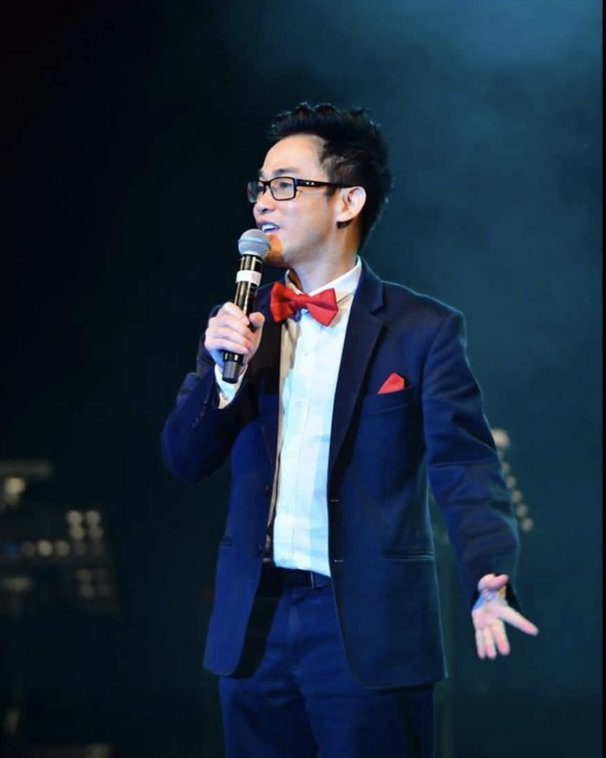 MC Lee Vu holding a microphone